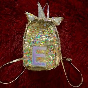Old justice gold sequence mini book-bag. Letter E